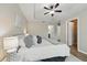 Main bedroom featuring laminate flooring, a ceiling fan, and an ensuite bathroom entrance for added convenience at 1575 Downy Birch Ln, Longwood, FL 32750