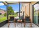 Enclosed lanai patio area offering shaded seating, a patterned tile floor, and a grassy lawn view at 1575 Downy Birch Ln, Longwood, FL 32750