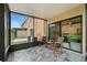 Relaxing screened patio with stylish tile flooring and comfortable rocking chairs overlooking the backyard at 1575 Downy Birch Ln, Longwood, FL 32750