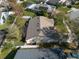 An aerial view shows the backyard of a single Gathering home with white fences and neighboring residences at 1662 Canoe Creek Rd, Oviedo, FL 32766