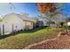 A well-kept yard features mature trees, landscaping, and a view of the house from the yard's edge at 1662 Canoe Creek Rd, Oviedo, FL 32766