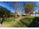 The serene backyard features lush greenery, mature trees, a fountain, and a well-maintained lawn, offering privacy at 1662 Canoe Creek Rd, Oviedo, FL 32766