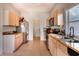 Bright kitchen with light wood cabinets, stainless appliances, granite countertops and ample storage space at 1662 Canoe Creek Rd, Oviedo, FL 32766