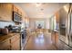 Eat-in kitchen features wooden cabinets, granite countertops, stainless steel appliances, and tile flooring at 1662 Canoe Creek Rd, Oviedo, FL 32766