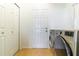 A dedicated laundry room features a modern washer and dryer unit with neutral tones at 1662 Canoe Creek Rd, Oviedo, FL 32766