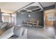 Open-concept living and dining area featuring modern gray walls, coffered ceiling, and sleek wood floors at 1662 Canoe Creek Rd, Oviedo, FL 32766