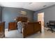 Main bedroom featuring wood furniture and a king size bed with a gray accent wall at 1662 Canoe Creek Rd, Oviedo, FL 32766