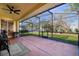 The screened-in patio includes a brick floor and ceiling fan, with an outdoor view of the well maintained back yard at 1662 Canoe Creek Rd, Oviedo, FL 32766