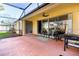 The screened-in lanai with brick flooring offers a seamless transition between indoor and outdoor living at 1662 Canoe Creek Rd, Oviedo, FL 32766