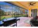 View of the screened-in patio with outdoor grill and comfortable seating, perfect for entertaining and relaxing at 1662 Canoe Creek Rd, Oviedo, FL 32766