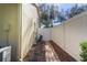 A side yard features manicured landscaping, a brick pathway, a white privacy fence, and access to the home's exterior at 1662 Canoe Creek Rd, Oviedo, FL 32766