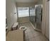 Bathroom with tile floors, glass enclosed shower, and window for natural light at 1868 Hammock Moss Dr, Orlando, FL 32820
