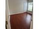 Comfortable bedroom featuring wood laminate floors, a closet, and a bright window at 1868 Hammock Moss Dr, Orlando, FL 32820