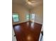 Main bedroom with hardwood floors, two windows, ceiling fan and ensuite bathroom at 1868 Hammock Moss Dr, Orlando, FL 32820