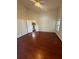 Bedroom with hardwood floors, ceiling fan, and view into the kitchen at 1868 Hammock Moss Dr, Orlando, FL 32820