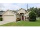 Charming single-Gathering home with a two-car garage, manicured lawn, and inviting front entrance at 1868 Hammock Moss Dr, Orlando, FL 32820