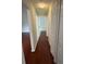 Hallway with laminate wood floors, leading to several rooms with neutral walls and white trim at 1868 Hammock Moss Dr, Orlando, FL 32820