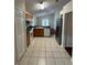 Traditional kitchen featuring stainless steel refrigerator, tile flooring, and wood cabinets at 1868 Hammock Moss Dr, Orlando, FL 32820