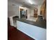 A kitchen with stainless steel refrigerator, breakfast bar, tile flooring, and wooden cabinets at 1868 Hammock Moss Dr, Orlando, FL 32820