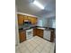 Well-lit kitchen with oak cabinets, modern appliances, and a functional layout for cooking at 1868 Hammock Moss Dr, Orlando, FL 32820