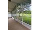 Inviting screened porch with serene views of the fenced backyard and mature trees at 1868 Hammock Moss Dr, Orlando, FL 32820