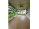 Screened-in patio with tile flooring, ceiling fan and backyard view at 1868 Hammock Moss Dr, Orlando, FL 32820