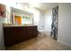 Functional bathroom with a double sink vanity, tiled floors, and a shower-tub combination at 208 Oleander St, Winter Haven, FL 33881