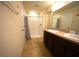 Bright bathroom featuring a double vanity, walk-in shower with tile surround, and neutral tones at 208 Oleander St, Winter Haven, FL 33881