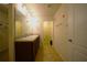 Bathroom with a double vanity, tile flooring, decorated with butterfly accents, and white door at 208 Oleander St, Winter Haven, FL 33881