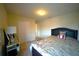 Bright bedroom with a floral bedspread, carpeted floors, and minimalist decor at 208 Oleander St, Winter Haven, FL 33881