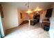 Open kitchen featuring an island, dark cabinets, tile flooring, and modern lighting at 208 Oleander St, Winter Haven, FL 33881