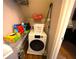 Small laundry room with front load washing machine and storage shelving at 208 Oleander St, Winter Haven, FL 33881