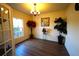 Living room with wood floors, natural light from the window, and decorative plants creating a cozy atmosphere at 208 Oleander St, Winter Haven, FL 33881