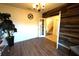 Living room with wood floors, modern light fixture, and a view into the stairway and adjoining room at 208 Oleander St, Winter Haven, FL 33881