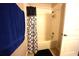 Shower and tub combination with tile surround, shower curtain and mounted shower head with handle at 208 Oleander St, Winter Haven, FL 33881