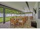 Expansive covered back patio featuring an outdoor dining area and lounge space overlooking the backyard at 2112 Fosgate Dr, Winter Park, FL 32789