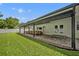 Exterior view of a home featuring a covered patio and manicured lawn with a privacy fence at 2112 Fosgate Dr, Winter Park, FL 32789