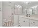 Well-lit bathroom featuring a glass-enclosed shower and modern vanity with marble countertop and accent tile flooring at 2112 Fosgate Dr, Winter Park, FL 32789