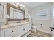 Bathroom features a vanity with a framed mirror, a toilet, a large window, and neutral paint at 2112 Fosgate Dr, Winter Park, FL 32789