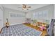 bedroom with hardwood floors, large windows with plantation shutters, and ample space for play and relaxation at 2112 Fosgate Dr, Winter Park, FL 32789
