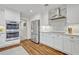 Modern kitchen with stainless steel appliances, white cabinets, and tile backsplash at 2112 Fosgate Dr, Winter Park, FL 32789