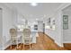 Modern, all-white kitchen featuring updated appliances, marble countertops, and stylish barstool seating at 2112 Fosgate Dr, Winter Park, FL 32789