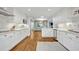 Bright kitchen with white cabinets, stainless steel appliances, marble countertops, and hardwood floors at 2112 Fosgate Dr, Winter Park, FL 32789