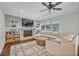 Inviting living room featuring brick fireplace, built-in bookshelves, and stylish ceiling fan at 2112 Fosgate Dr, Winter Park, FL 32789