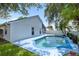 Backyard view of the pool with lush lawn and beautiful trees and plantings at 222 Imperial Ridge Ct, Oviedo, FL 32765