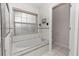 Bathroom with tiled tub, shower, window, and commode at 222 Imperial Ridge Ct, Oviedo, FL 32765