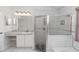 Tiled bathroom featuring a spacious glass shower and sink with cabinet storage at 222 Imperial Ridge Ct, Oviedo, FL 32765