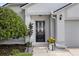 Inviting front entrance featuring a decorative door, manicured shrubs, and a well-maintained walkway at 222 Imperial Ridge Ct, Oviedo, FL 32765