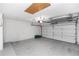 Spacious garage with white brick walls, epoxy floor and garage door opener and plenty of storage space at 222 Imperial Ridge Ct, Oviedo, FL 32765