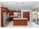 Open-concept kitchen with granite countertops, stainless steel appliances, and a spacious island for seating at 222 Imperial Ridge Ct, Oviedo, FL 32765